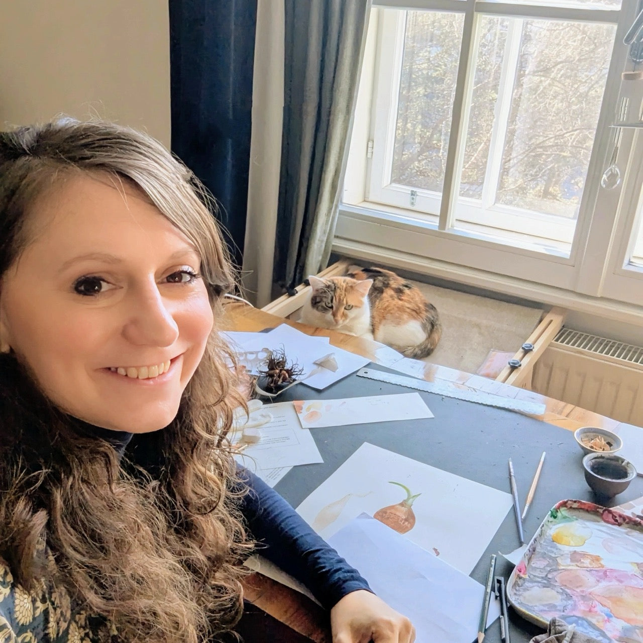 Frau mit Katze an Schreibtisch